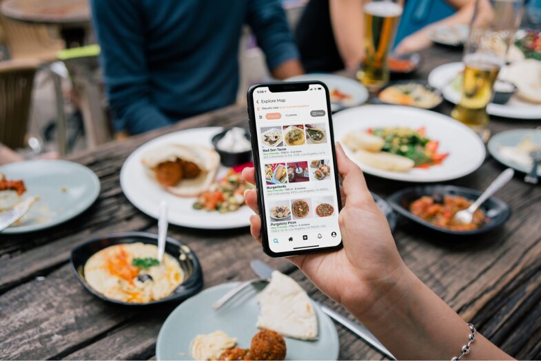 A person viewing the restaurant menu on his mobile phone